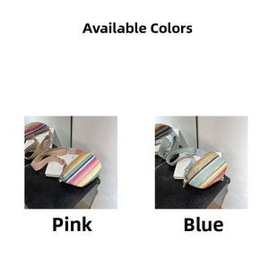 Detail of bohemian straw waist bags in pink and blue stripes with wide shoulder straps
