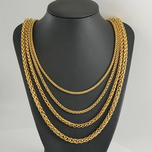 Detailed layered display of four golden spiga wheat chains in varying thicknesses