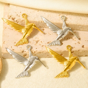 Macro shot of 304 stainless steel hummingbird charms in gold and silver for DIY jewelry