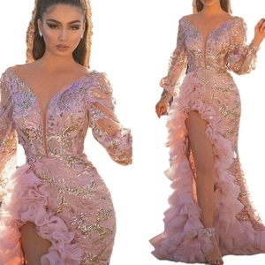 Detail of pink evening dress featuring gold sequin embroidery and layered ruffles