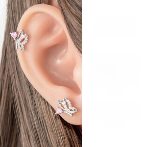 Detailed view of titanium steel butterfly ear cuff with pink heart crystal and blue stones