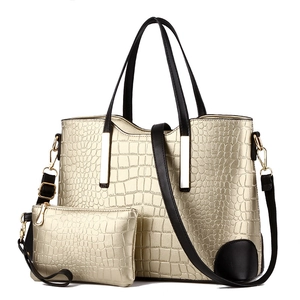 Two-piece stone pattern tote set with large gold shoulder bag and matching small pouch