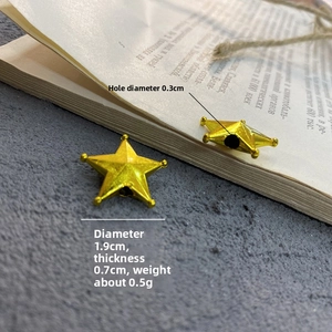 Macro shot of small golden star beads for Christmas DIY crafts with dimensions