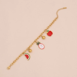 Detail of gold necklace with watermelon and apple fruit pendants on clean background