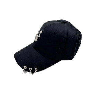 Detail of black baseball cap featuring silver star ornament and triple metal rings on brim