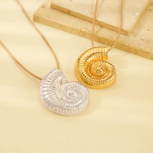 Close-up of nautilus seashell pendants in gold and silver finish for long necklaces