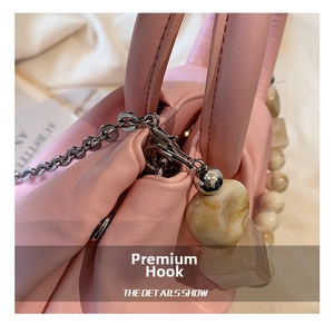 Detail of pink cloud bag showing soft pleated leather and marble bead chain hook