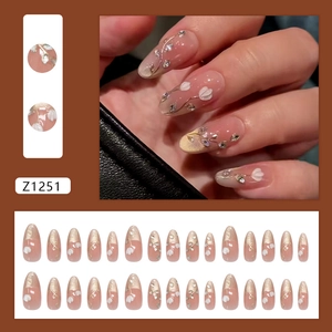 Nude pink cat eye press-on nails set with 3D white flowers and sparkling rhinestones