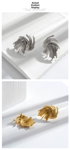 Macro detail of wheat ear earrings with brushed metal texture in gold and silver