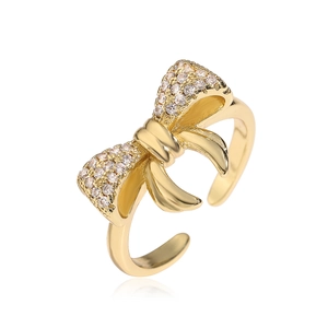 Elegant gold bow open ring featuring cubic zirconia accents and adjustable band