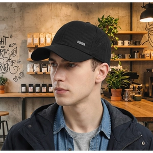 Detail view of black breathable mesh sports cap with metal logo plate for men