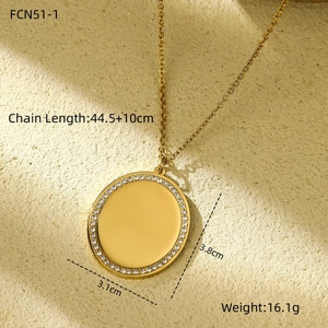 Macro view of gold stainless steel oval pendant with inlaid crystals and dimension labels