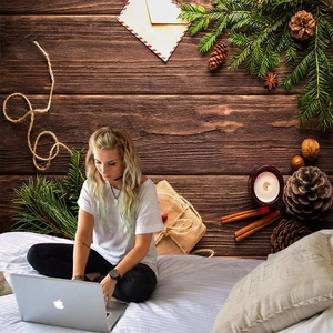 Winter themed wood grain wall tapestry featuring pine cones and cozy home decorations