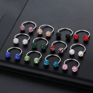 Macro display of twelve colorful horseshoe rings with shimmering crystal stud balls