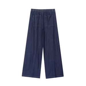 Detail view of dark blue denim wide-leg pants featuring back pockets and elastic waist