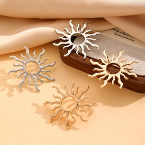 Polished sunburst stud earrings in gold and silver finishes with a wavy radial design