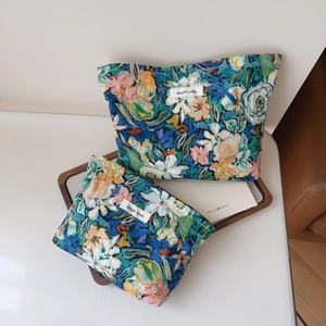 Detailed macro of floral quilted cotton storage bags with vintage blue and green oil painting prints