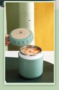 Detail of mint green insulated soup container with wood-grain lid showing shrimp porridge