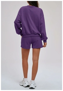 Rear view of deep purple women's tracksuit with ribbed sweatshirt and patch pocket shorts