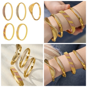 Detailed macro view of 18k gold plated stainless steel bangles set with zircon crystals