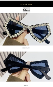 Close-up of butterfly oversized sunglasses with sparkling rhinestones on black frames