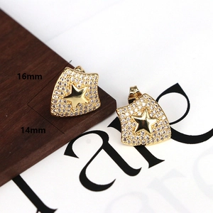 Detailed close-up of gold-plated star studs with white cubic zirconia pavé stones