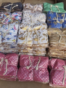 Detailed view of assorted linen pattern fabrics bundled and packed for tote bag manufacturing