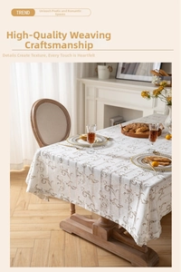 Detail of elegant jacquard table runner with golden scroll pattern on linen fabric