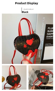 Detail of heart-shaped black crocodile texture handbag with red cupid arrow embroidery