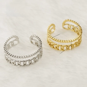 Detail of adjustable double-layer 18K gold ring showing ball and Cuban chain texture