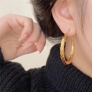 Chic vintage golden twisted metal hoop earrings for women in retro textured style