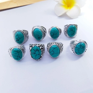 Detail view of vintage alloy rings with turquoise stones and floral engravings