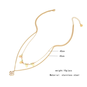 Double-layered gold stainless steel necklace featuring crystal beads and clover pendant