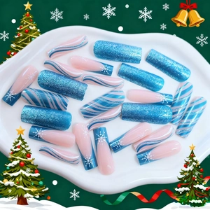 Christmas long press-on nails with blue glitter and snowflake designs in festive layout