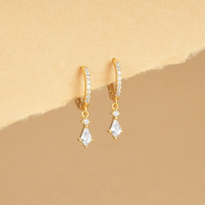 Detailed view of gold hoop earrings featuring kite-shaped crystals and zircon stones
