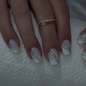 Square faux nails featuring white and grey marble patterns with golden glitter lines