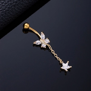 Close-up of golden butterfly belly ring with sparkling zircon and star-shaped pendant