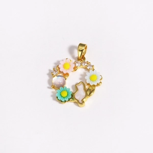 Detailed close-up of a golden cat pendant with colorful flowers and zircon stones