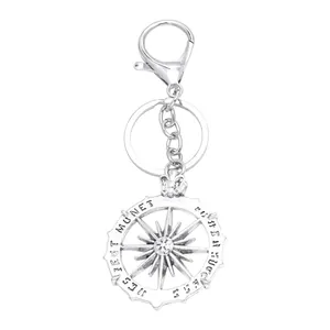 Silver hip hop alloy car keychain with sun map medallion and lobster clasp on white background