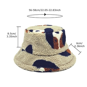 Sherpa fleece dog-ear bucket hat with cow print and size measurements in beige