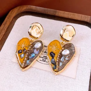 French vintage heart pendant earrings with gold finish, marble texture and pearl accents