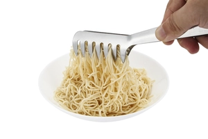 Macro detail of stainless steel claw tongs picking up pasta from a white ceramic bowl