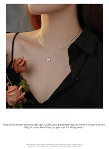 Detail of s999 sterling silver crescent moon necklace with sparkling zircon on a model