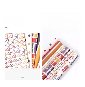 Detailed close-up of colorful heart and star patterns on premium birthday gift wrapping paper