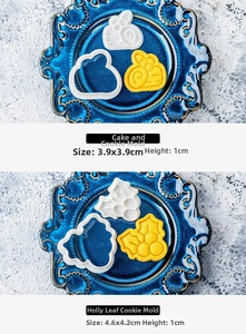 Detail view of bee and holly leaf cookie stamps on a blue plate with dough cutouts