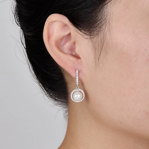 Elegant S925 sterling silver pearl earrings with zircon inlay on a model