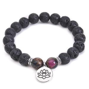 Detail of 10mm black lava stone beads and silver lotus pendant on an elastic yoga bracelet