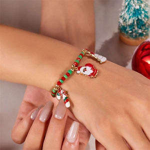 Close-up of Christmas beaded bracelet with Santa and candy cane charms on a model wrist