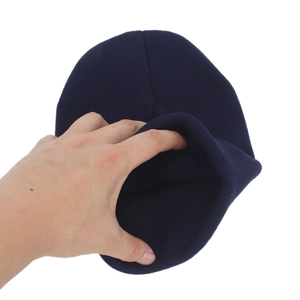 Dark blue knitted beanie for women featuring a minimalist M label and warm ribbed fabric