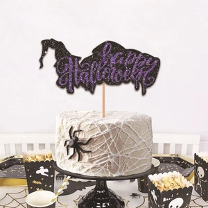 Glittery Happy Halloween cake topper with witch silhouette on party table setup